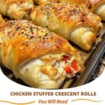 Golden, flaky crescent rolls stuffed with tender chicken and cheese, fresh out of the oven, with a light golden crust.