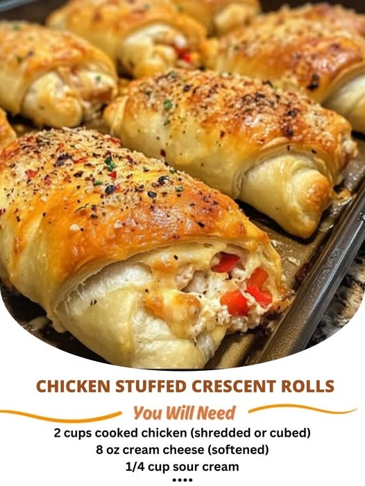 Golden, flaky crescent rolls stuffed with tender chicken and cheese, fresh out of the oven, with a light golden crust.