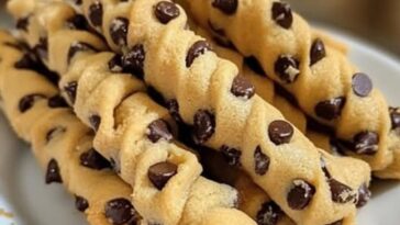 Golden, twisted pastry filled with chocolate chip cookie dough and dusted with powdered sugar.