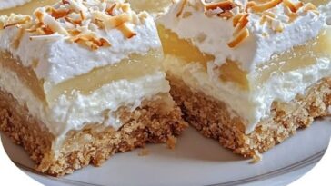 Delicious coconut cream pie bars with a creamy coconut filling, topped with toasted coconut flakes and a buttery crust.