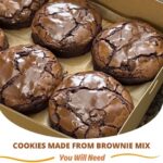 Chocolate brownie mix cookies stacked on a plate, with a cracked, fudgy surface and rich, dark color.