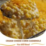 Baked cream cheese corn casserole in a dish, golden and bubbly on top with visible corn kernels and melted cheese.