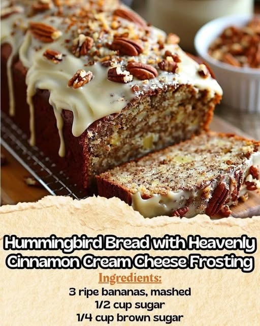 A moist slice of banana bread topped with thick cream cheese frosting and garnished with toasted coconut and pineapple pieces.