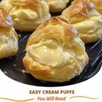 Light and airy cream puffs filled with fluffy whipped cream, dusted with powdered sugar on a plate.
