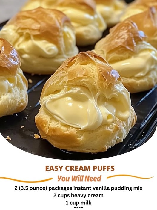 Light and airy cream puffs filled with fluffy whipped cream, dusted with powdered sugar on a plate.
