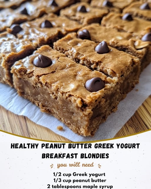 Stack of healthy peanut butter Greek yogurt blondies on a white plate, drizzled with peanut butter and sprinkled with oats.