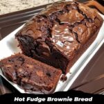 Warm slices of hot fudge brownie bread with gooey fudge drizzle, placed on a rustic wooden board.