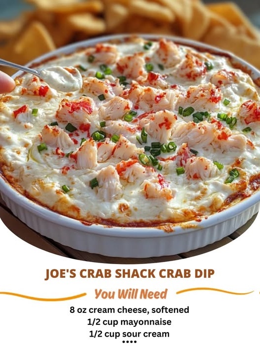Creamy crab dip in a skillet, topped with melted cheese and served with toasted bread slices.