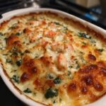 Hot, cheesy crab, shrimp, and spinach dip served bubbling in a skillet with tortilla chips on the side.
