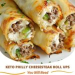 Keto Philly Cheesesteak roll-ups featuring thinly sliced steak, sautéed bell peppers, onions, and melted cheese, all wrapped in a low-carb, flourless wrap, garnished with fresh herbs.