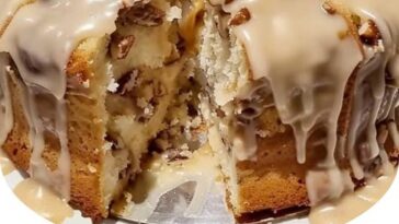 slice of pineapple pecan cream cheese pound cake on a white plate, showcasing a moist, golden crumb with visible pecan pieces and a hint of pineapple.