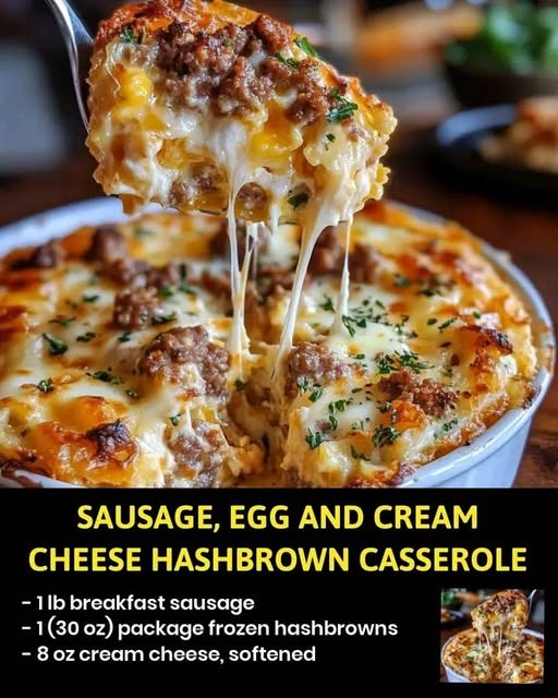 Sausage, egg, and cream cheese hashbrown casserole topped with melted cheese, served hot in a baking dish.