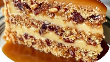 Southern Pecan Caramel Cake with a rich caramel glaze and topped with crunchy pecans.