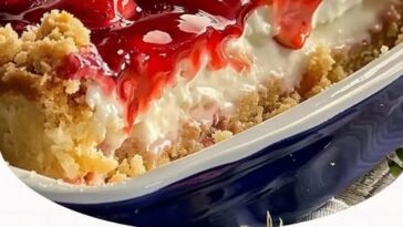 Strawberry cheesecake dump cake with a golden crumb topping, swirls of cream cheese, and juicy strawberry filling.