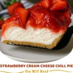 A slice of strawberry cream cheese chill pie with a graham cracker crust, topped with fresh strawberry slices and whipped cream.