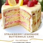 Strawberry lemonade buttermilk cake topped with fresh strawberries and a light glaze, sliced and ready to serve.