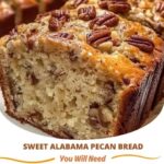 Golden-brown slices of Sweet Alabama Pecan Bread with visible chunks of pecans, sitting on a rustic wooden table