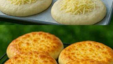 A rustic loaf of golden-brown cheesy bread with a crisp crust and melted cheese pockets visible on the surface.