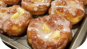 Warm, golden baked apple fritters with a sweet, cinnamon-spiced apple filling, dusted with powdered sugar. The perfect fall treat.