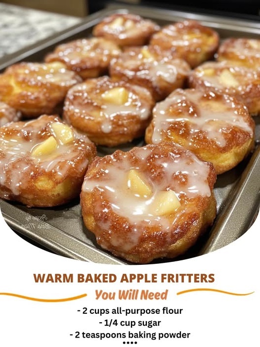 Warm, golden baked apple fritters with a sweet, cinnamon-spiced apple filling, dusted with powdered sugar. The perfect fall treat.