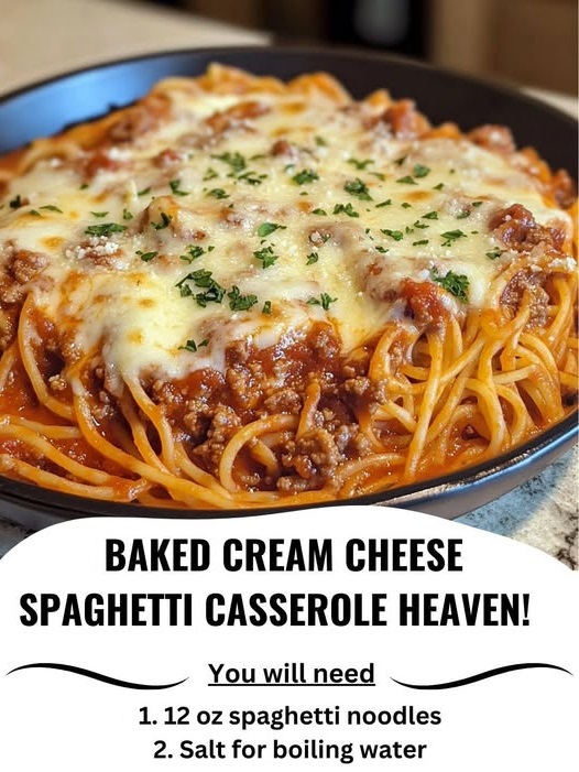 A slice of baked cream cheese spaghetti casserole on a plate, with layers of creamy pasta, meat sauce, and melted cheese.