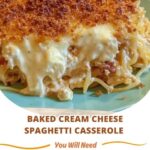 A serving of baked cream cheese spaghetti casserole, with melted cheese on top, rich tomato sauce, and creamy pasta layers.