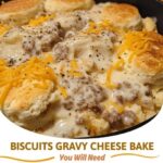 A hearty slice of biscuits and gravy hashbrown casserole with golden biscuits, creamy sausage gravy, and crispy hashbrowns.