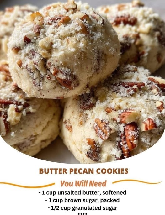 Freshly baked butter pecan cookies with golden brown edges and chopped pecans on top, arranged on a cooling rack.