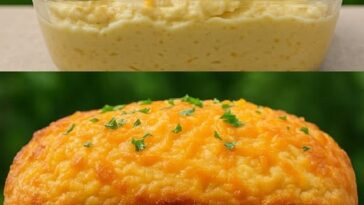 A loaf of golden-brown cheddar cheese quick bread with a crusty exterior, sliced to reveal the cheesy interior.