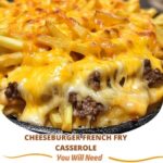 Baked casserole topped with golden French fries, melted cheese, and ground beef in a baking dish.
