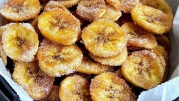 Crispy cinnamon-sugar banana chips served in a bowl, made in an air fryer.