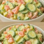 A bowl of creamy cucumber salad with sliced hard-boiled eggs, thin cucumber rounds, red onion slivers, and fresh dill, all coated in a smooth, creamy dressing.