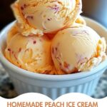 A bowl of creamy homemade peach ice cream garnished with fresh peach slices and a sprig of mint.