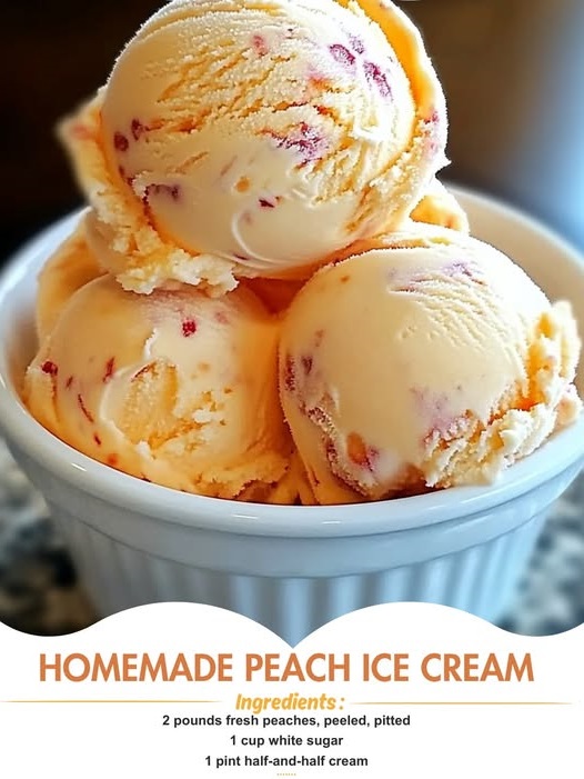 A bowl of creamy homemade peach ice cream garnished with fresh peach slices and a sprig of mint.