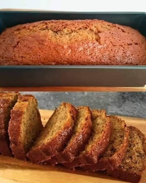 A thick, moist slice of banana bread with a golden-brown crust, served on a plate with a pat of butter melting on top.