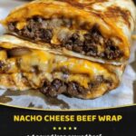 A hearty nacho cheese beef wrap, filled with seasoned ground beef, melted nacho cheese, lettuce, and tomato, all wrapped in a soft tortilla.
