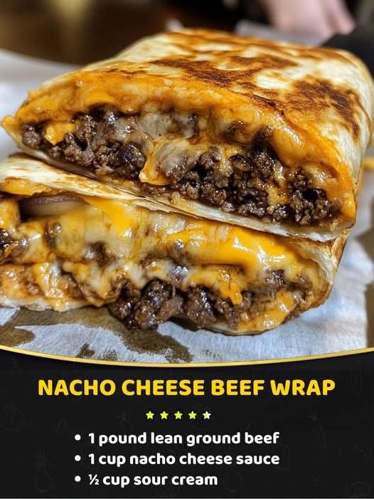 A hearty nacho cheese beef wrap, filled with seasoned ground beef, melted nacho cheese, lettuce, and tomato, all wrapped in a soft tortilla.
