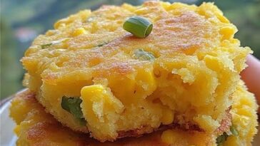 Golden, rustic cornbread with a crumbly texture, served in a cast iron skillet with a crispy crust.