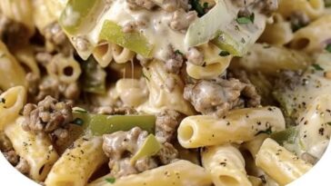 Creamy Philly cheesesteak pasta with sliced steak, bell peppers, onions, and melted cheese over tender pasta.
