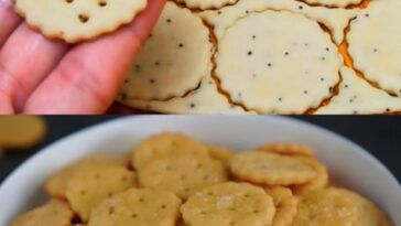 A mix of golden-brown salt crackers and lightly sugared salt cookies arranged on a rustic wooden board.