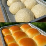 A batch of golden-brown, fluffy no-knead dinner rolls in a baking dish, freshly baked and slightly glistening on top.
