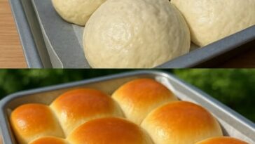 A batch of golden-brown, fluffy no-knead dinner rolls in a baking dish, freshly baked and slightly glistening on top.