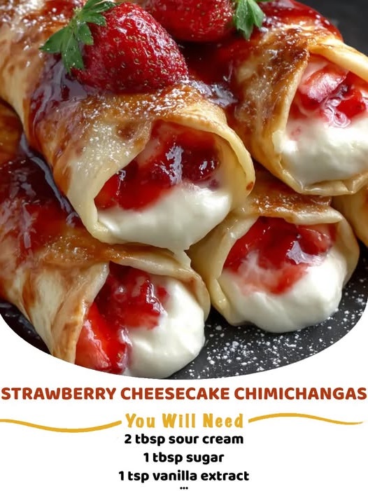 Golden-brown fried chimichangas filled with creamy cheesecake and strawberry filling, dusted with cinnamon sugar and topped with fresh strawberries.