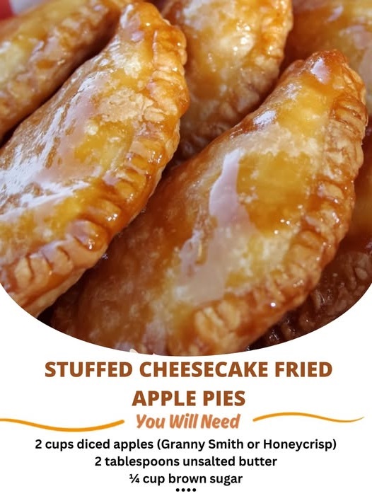 Golden, crispy hand pies stuffed with creamy cheesecake filling and spiced apples, with one pie cut open to reveal the gooey center.